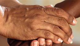 Two adults shaking hands.
